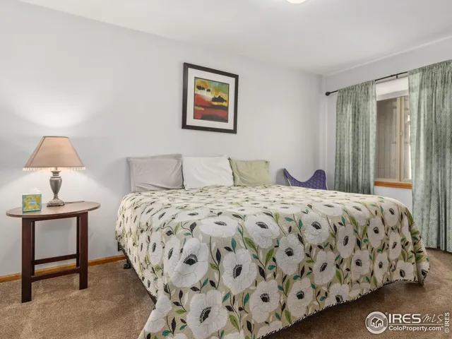 a bedroom with a bed and a lamp on table