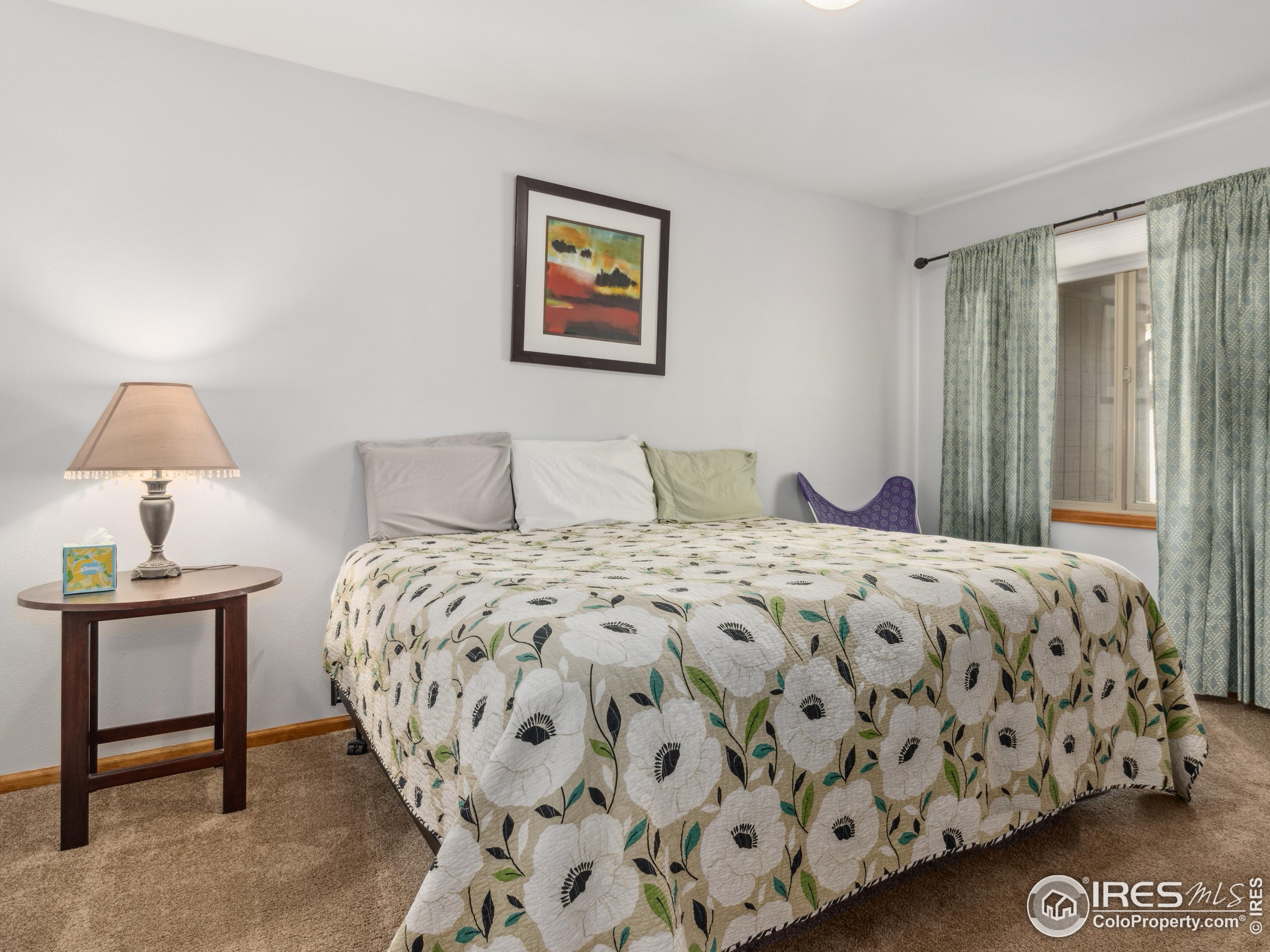 300 Far View Drive, Unit 7 Estes Park, CO 80517 - Photo 16 of 26 a bedroom with a bed and a lamp on table