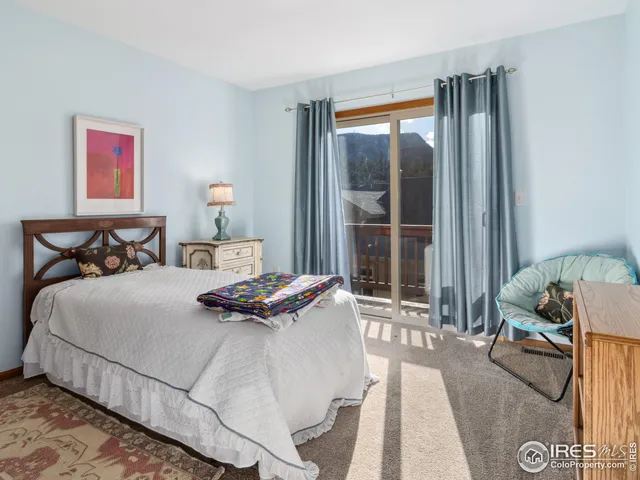 a bedroom with a bed and glass window