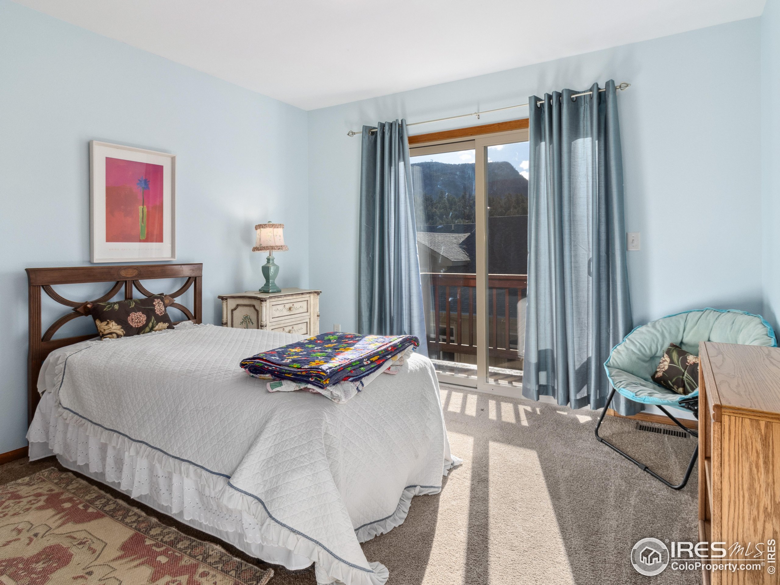 300 Far View Drive, Unit 7 Estes Park, CO 80517 - Photo 18 of 26 a bedroom with a bed and glass window