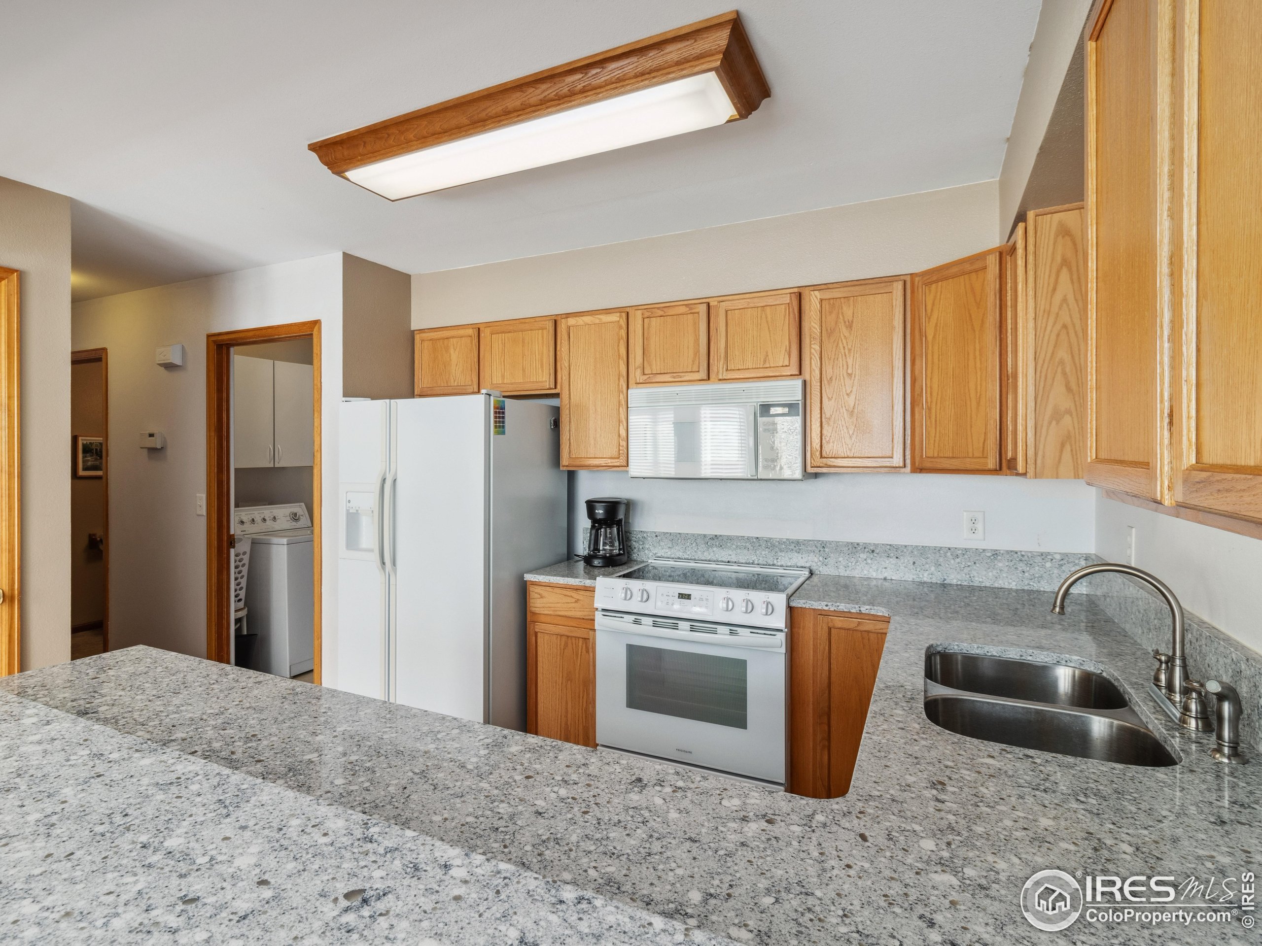 300 Far View Drive, Unit 7 Estes Park, CO 80517 - Photo 8 of 26 a kitchen with stainless steel appliances granite countertop a sink stove and refrigerator