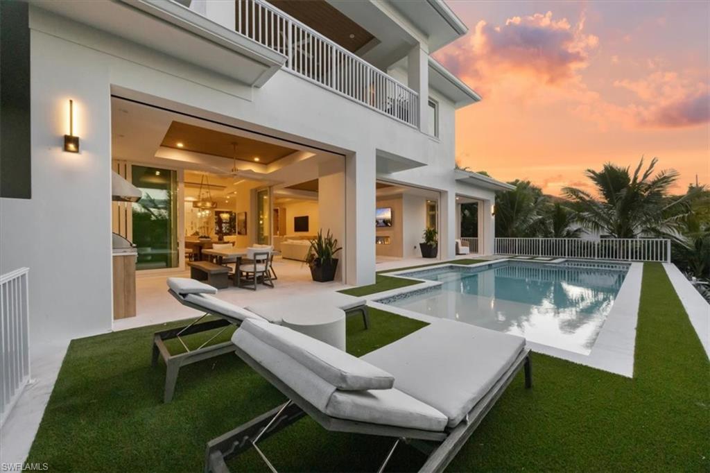 493 8th Avenue South Naples, FL 34102 - Photo 18 of 40 a view of a patio with swimming pool table and chairs