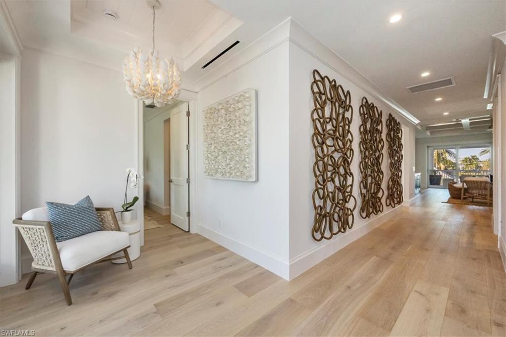 493 8th Avenue South Naples, FL 34102 - Photo 26 of 40 a view of a livingroom with furniture wooden floor and a chandelier