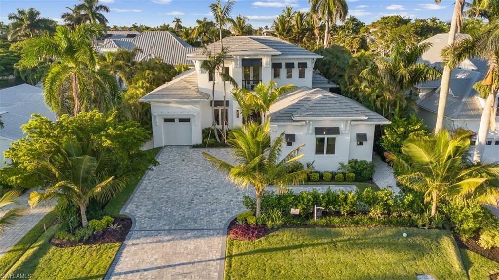 493 8th Avenue South Naples, FL 34102 - Photo 40 of 40 a front view of a house with a garden
