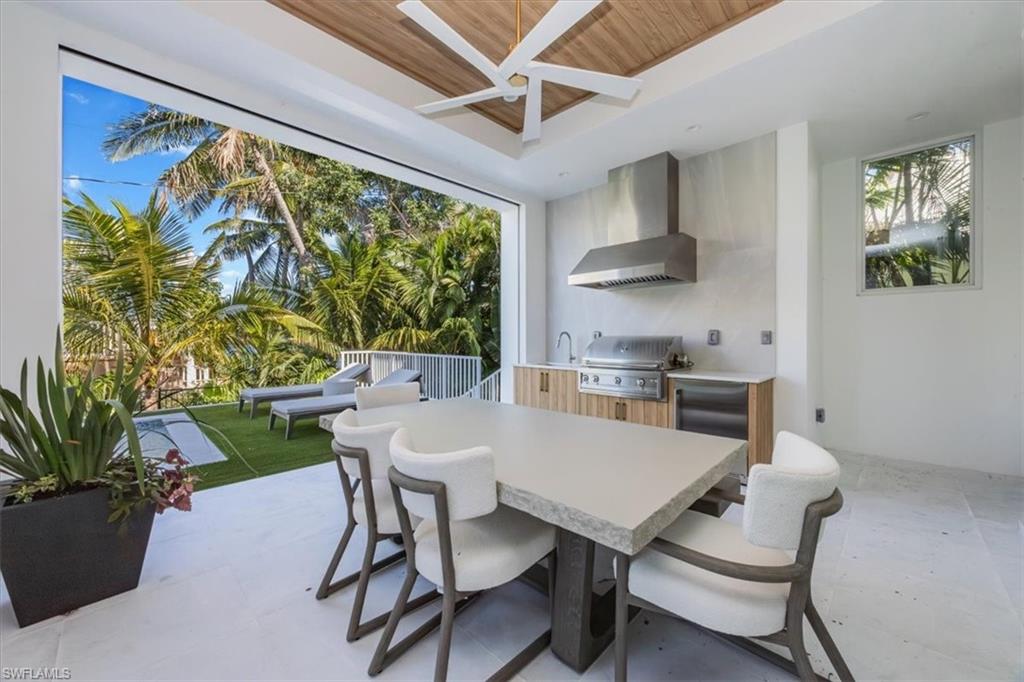 493 8th Avenue South Naples, FL 34102 - Photo 6 of 40 a kitchen with a table and chairs in it