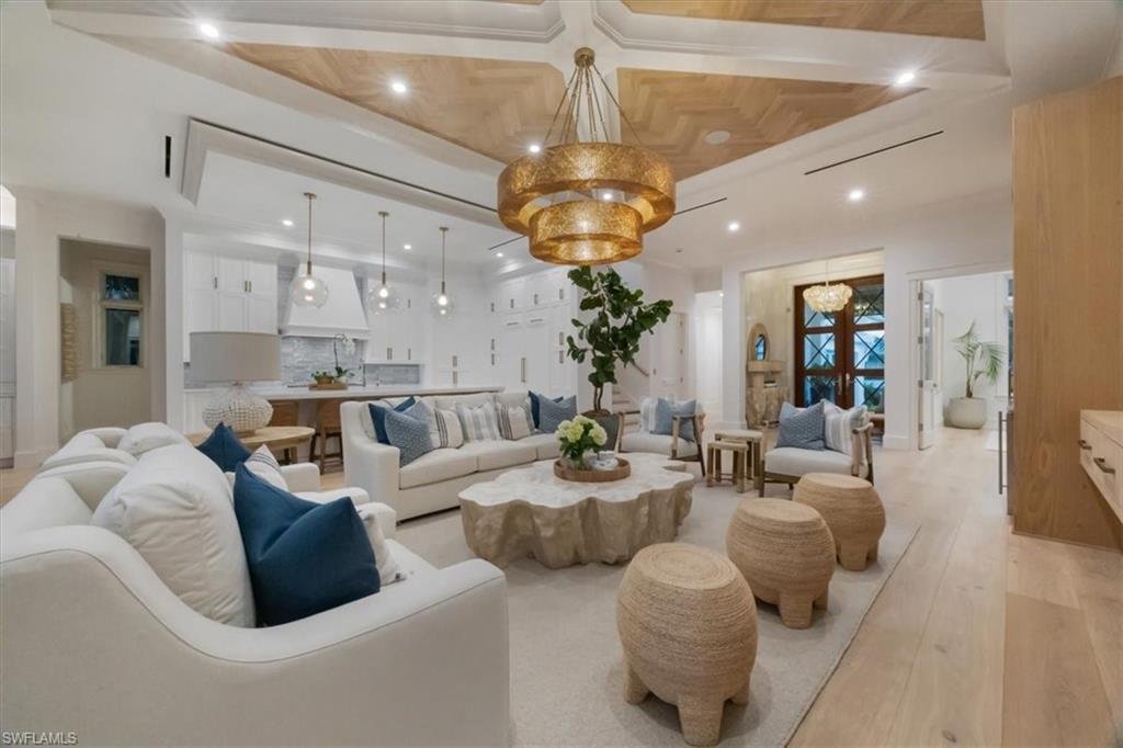 493 8th Avenue South Naples, FL 34102 - Photo 9 of 40 a living room with furniture kitchen and a chandelier