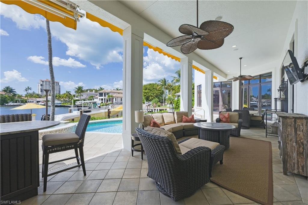 361 Pirates Bight Naples, FL 34103 - Photo 38 of 45 a living room with furniture a floor to ceiling window and outdoor view