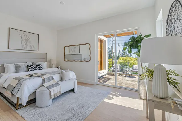a bedroom with bed and glass door