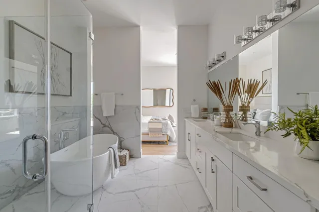 a spacious bathroom with a double vanity sink a mirror and a shower