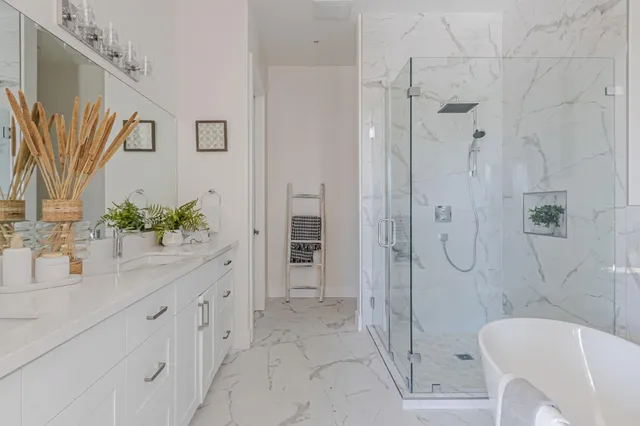 a bathroom with a double vanity sink toilet and shower