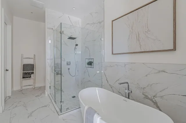 a bathroom with a bathtub and a shower