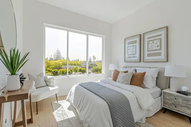 a bedroom with a large bed and a window