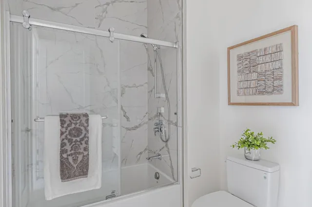 a bathroom with a shower curtain and a toilet