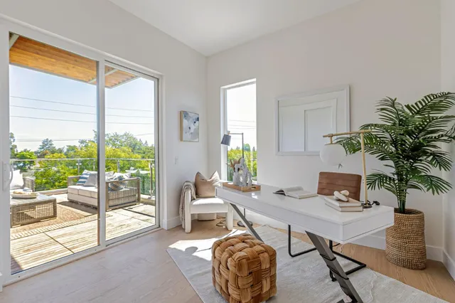 a work room with furniture and a potted plant