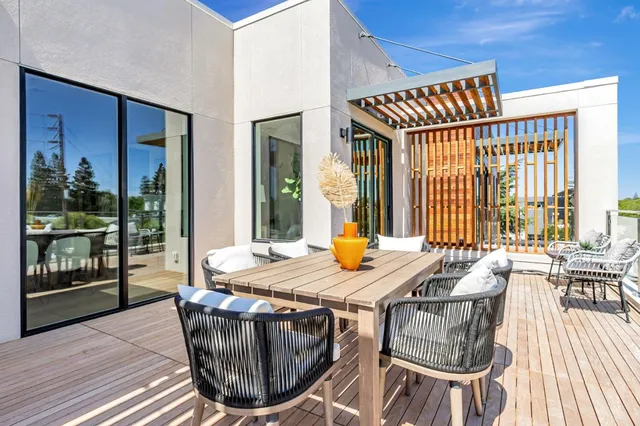 a view of a dining room with furniture large windows and wooden floor