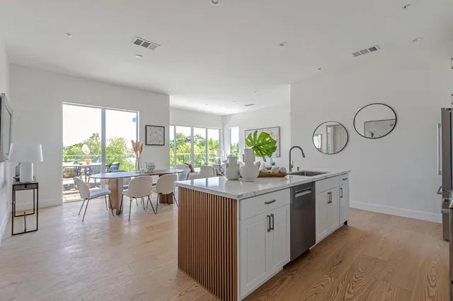 a kitchen with lots of counter top space and wooden floor