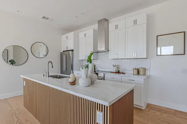 a kitchen with cabinets a sink and a stove top oven