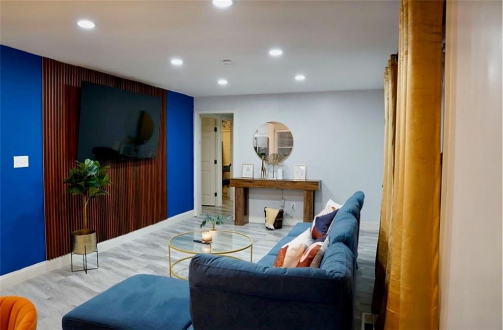 a living room with furniture and a potted plant