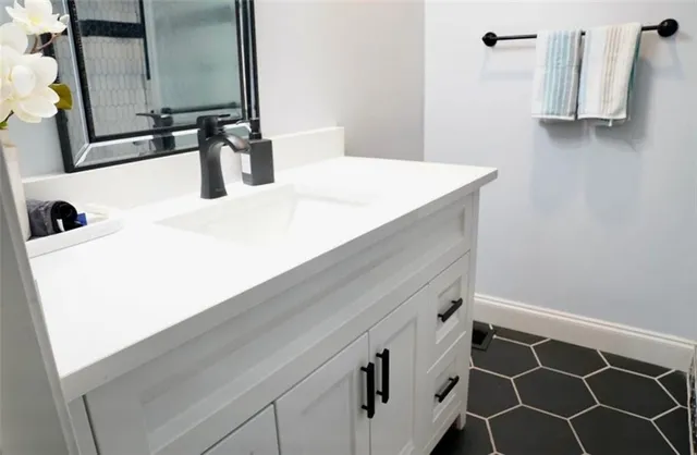 a bathroom with a sink and a mirror