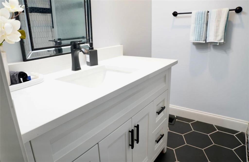 3812 Clovis Court Northwest Atlanta, GA 30331 - Photo 12 of 20 a bathroom with a sink and a mirror