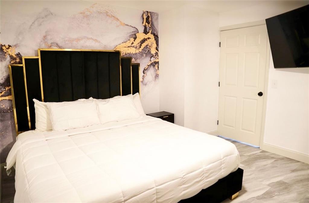 3812 Clovis Court Northwest Atlanta, GA 30331 - Photo 18 of 20 a bedroom with a bed and a flat tv screen