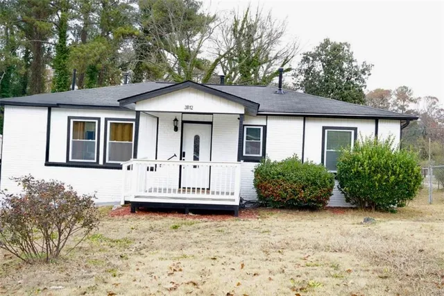 a balcony with a bench and white walls