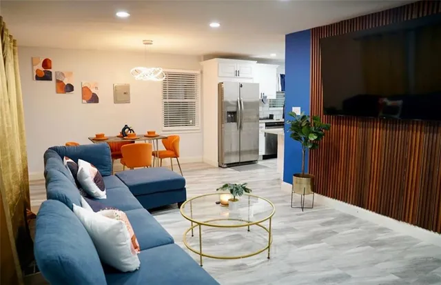 a living room with furniture and a flat screen tv