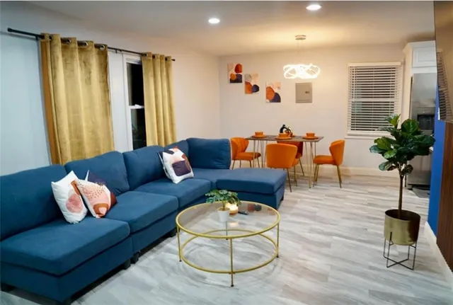 a living room with furniture and a large window