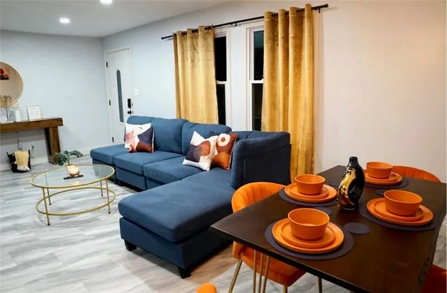 a living room with furniture and wooden floor