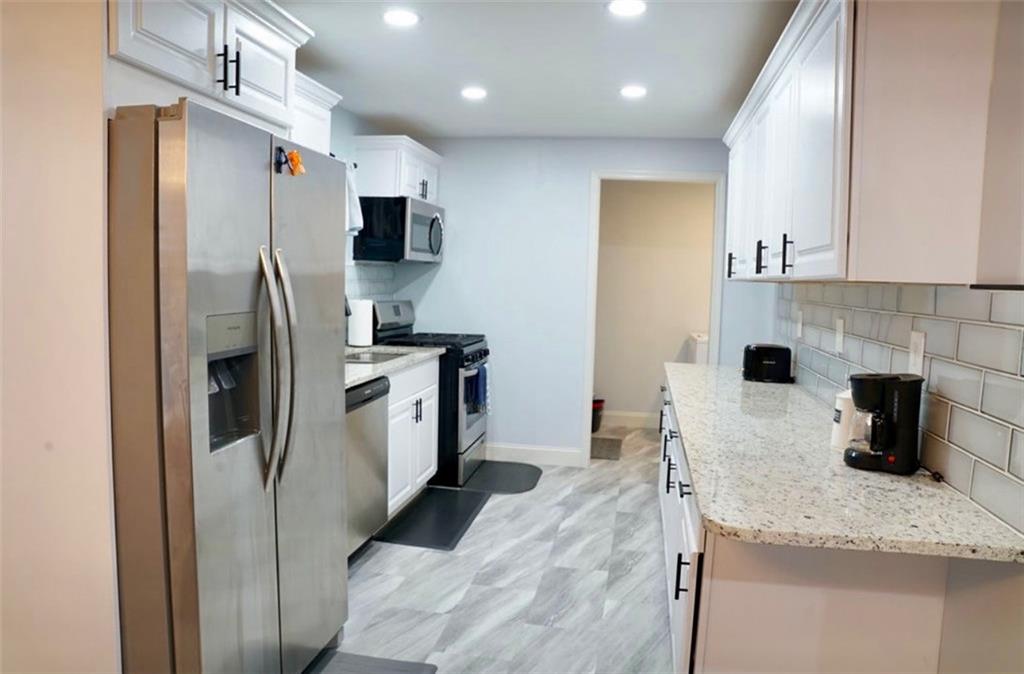 3812 Clovis Court Northwest Atlanta, GA 30331 - Photo 6 of 20 a kitchen with stainless steel appliances granite countertop a refrigerator a stove a sink and a microwave