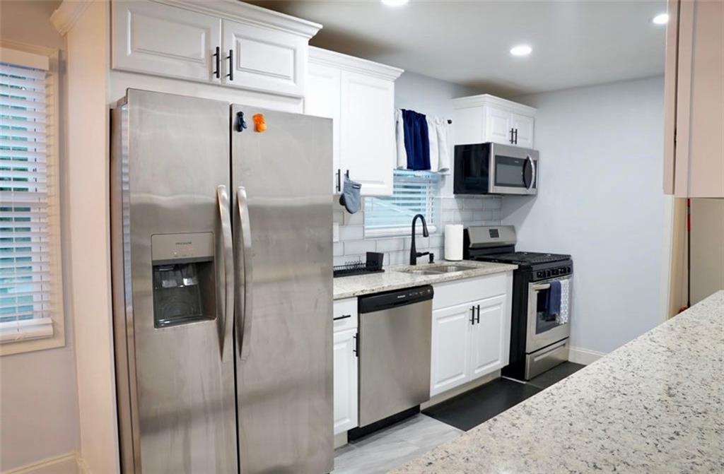 3812 Clovis Court Northwest Atlanta, GA 30331 - Photo 7 of 20 a kitchen with stainless steel appliances kitchen island a refrigerator sink and microwave