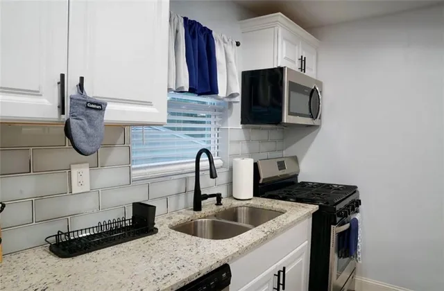 a kitchen with a sink and a stove top oven
