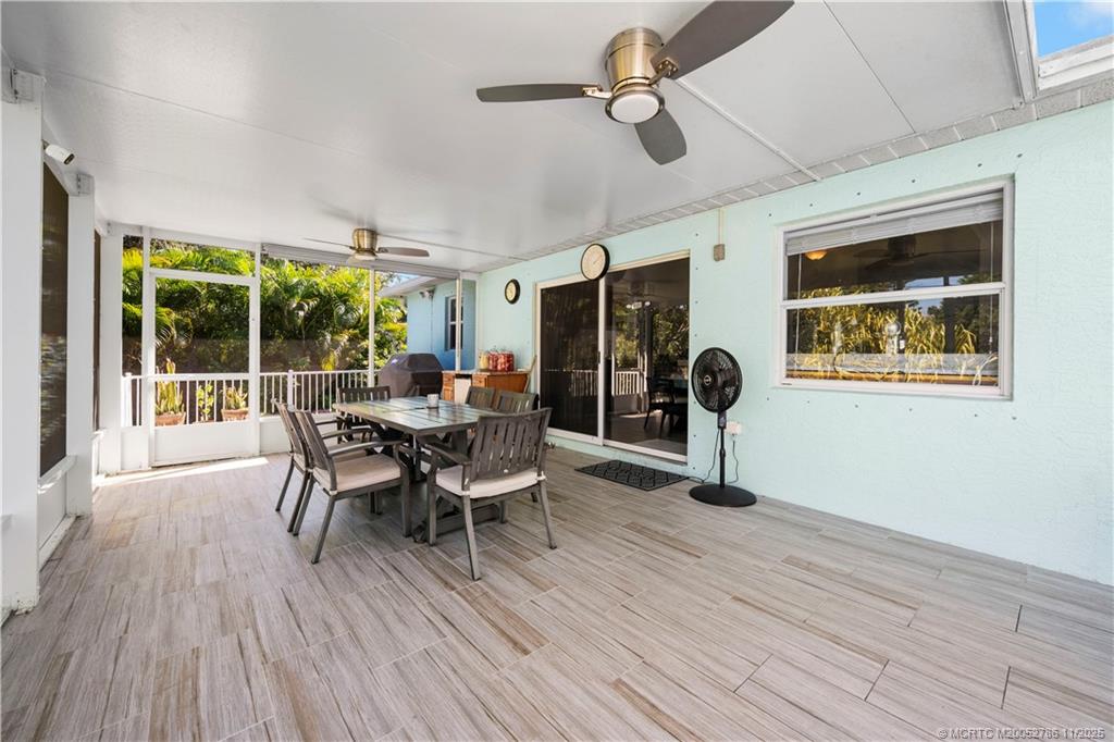 3785 Southeast Middle Street Stuart, FL 34997 - Photo 21 of 31 a living room with furniture and a large window
