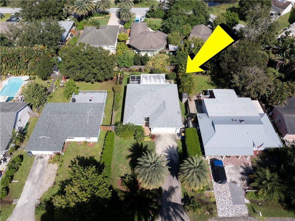 3785 Southeast Middle Street Stuart, FL 34997 - Photo 28 of 31 an aerial view of a house with swimming pool and lawn chairs