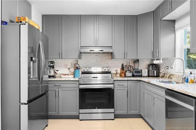 a kitchen with a sink stove and refrigerator