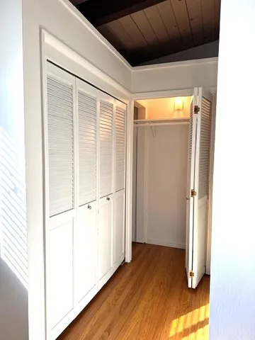 a view of a hallway with wooden floor