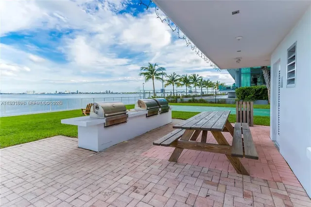 a view of a swimming pool and lounge chairs in back of a house
