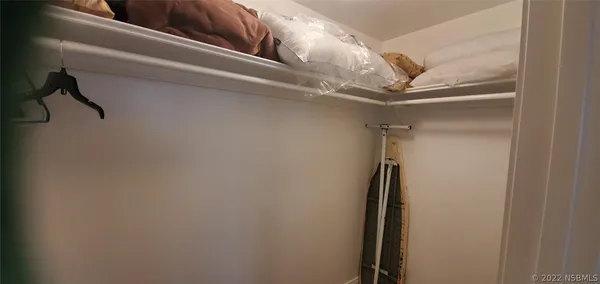 a living room with a bed and a window