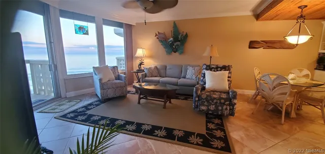 a view of a livingroom with furniture and a flat screen tv
