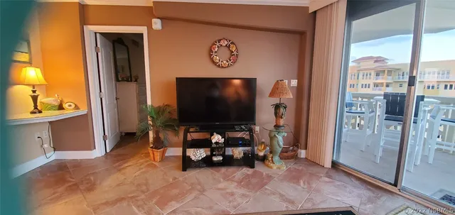 a view of a dining room with furniture a chandelier and wooden floor