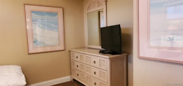 a bedroom with a bed and dresser
