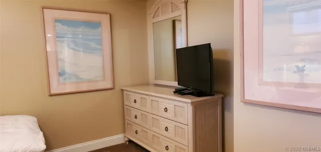 a bedroom with a bed and dresser