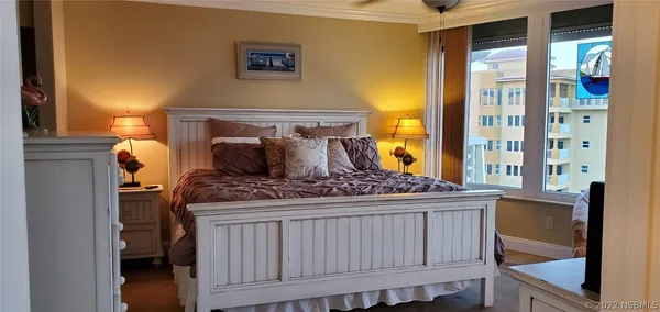 a bed sitting in a bedroom next to a window