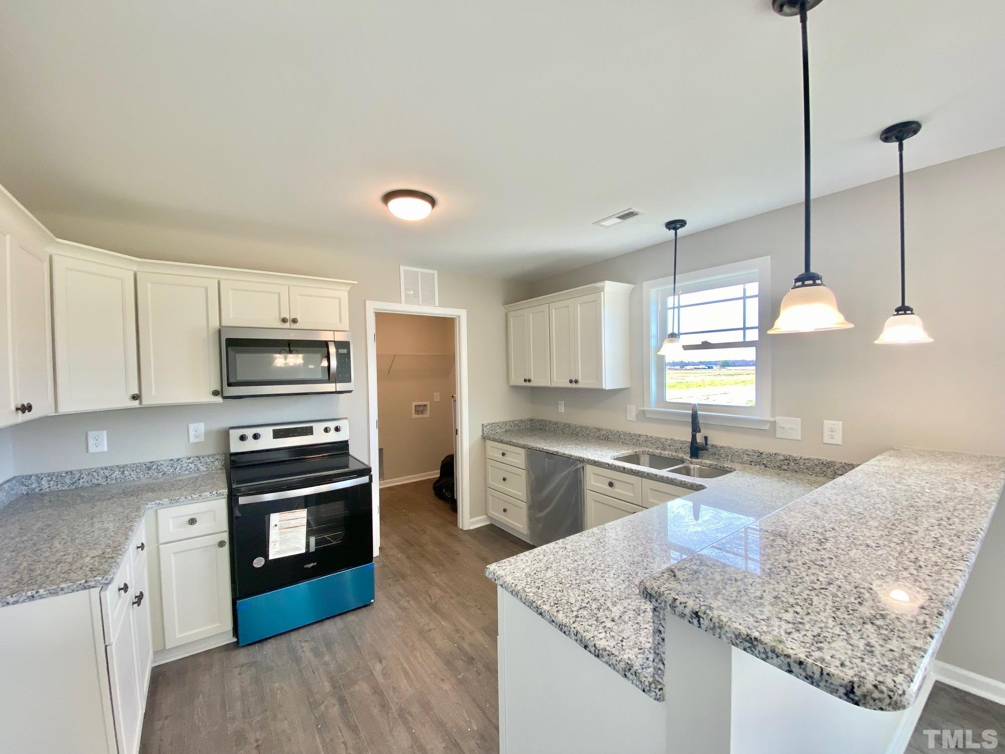 120 Mamie Road Benson, NC 27504 - Photo 16 of 35 a kitchen with stainless steel appliances granite countertop a sink stove and refrigerator