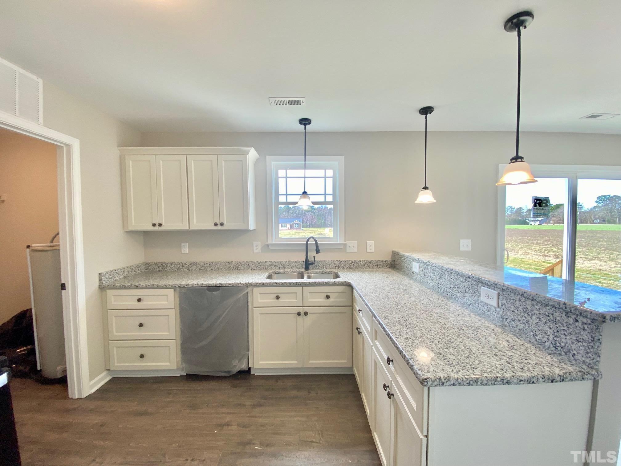 120 Mamie Road Benson, NC 27504 - Photo 17 of 35 a kitchen with a sink stove and cabinets