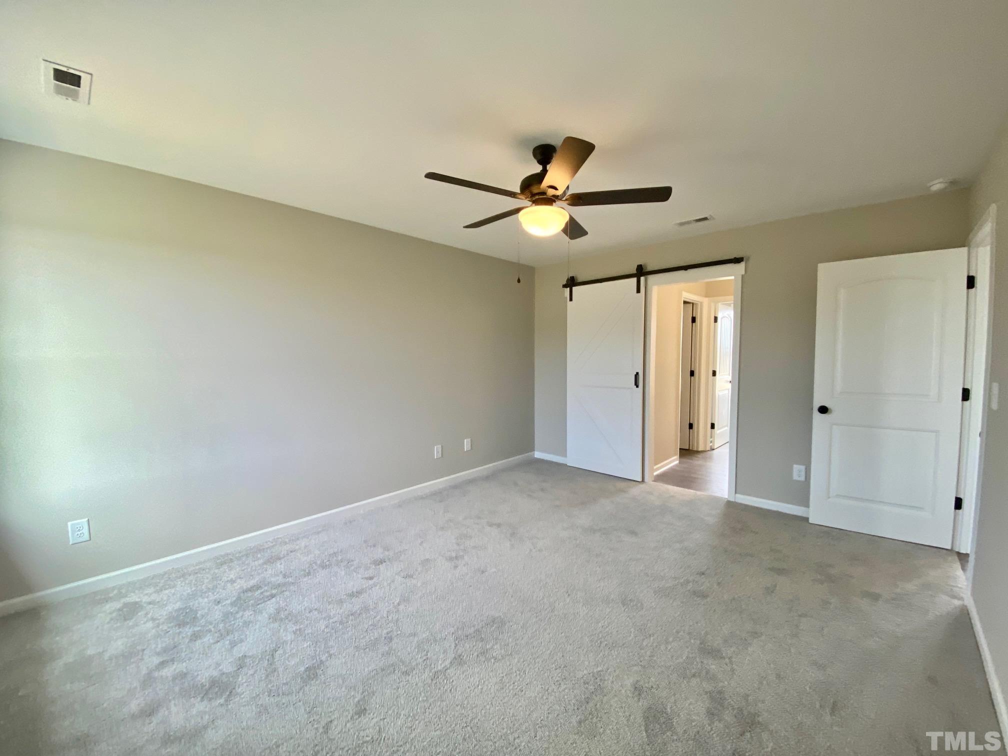 120 Mamie Road Benson, NC 27504 - Photo 21 of 35 an empty room with a ceiling fan and a shower