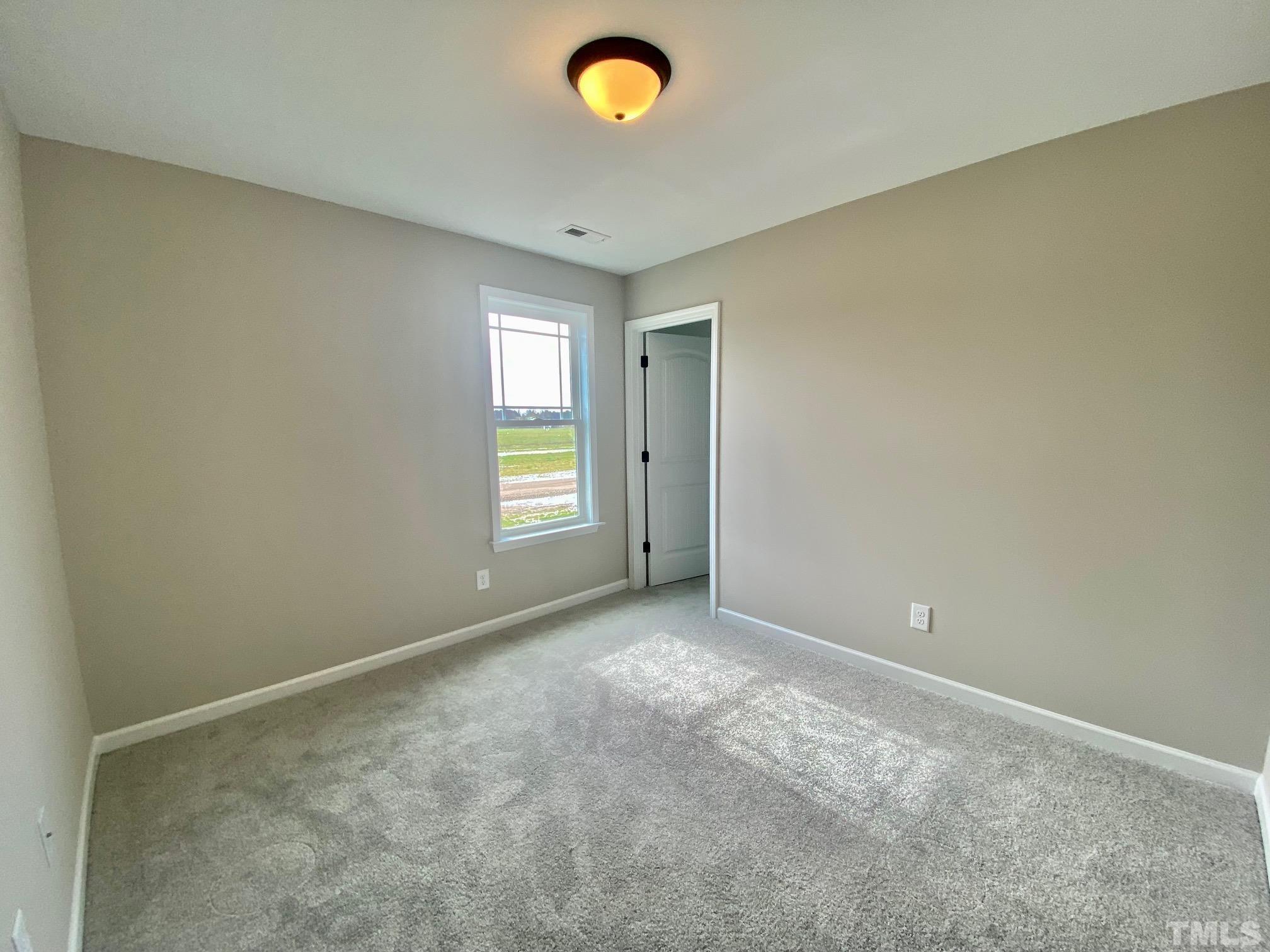 120 Mamie Road Benson, NC 27504 - Photo 32 of 35 an empty room with windows and closet