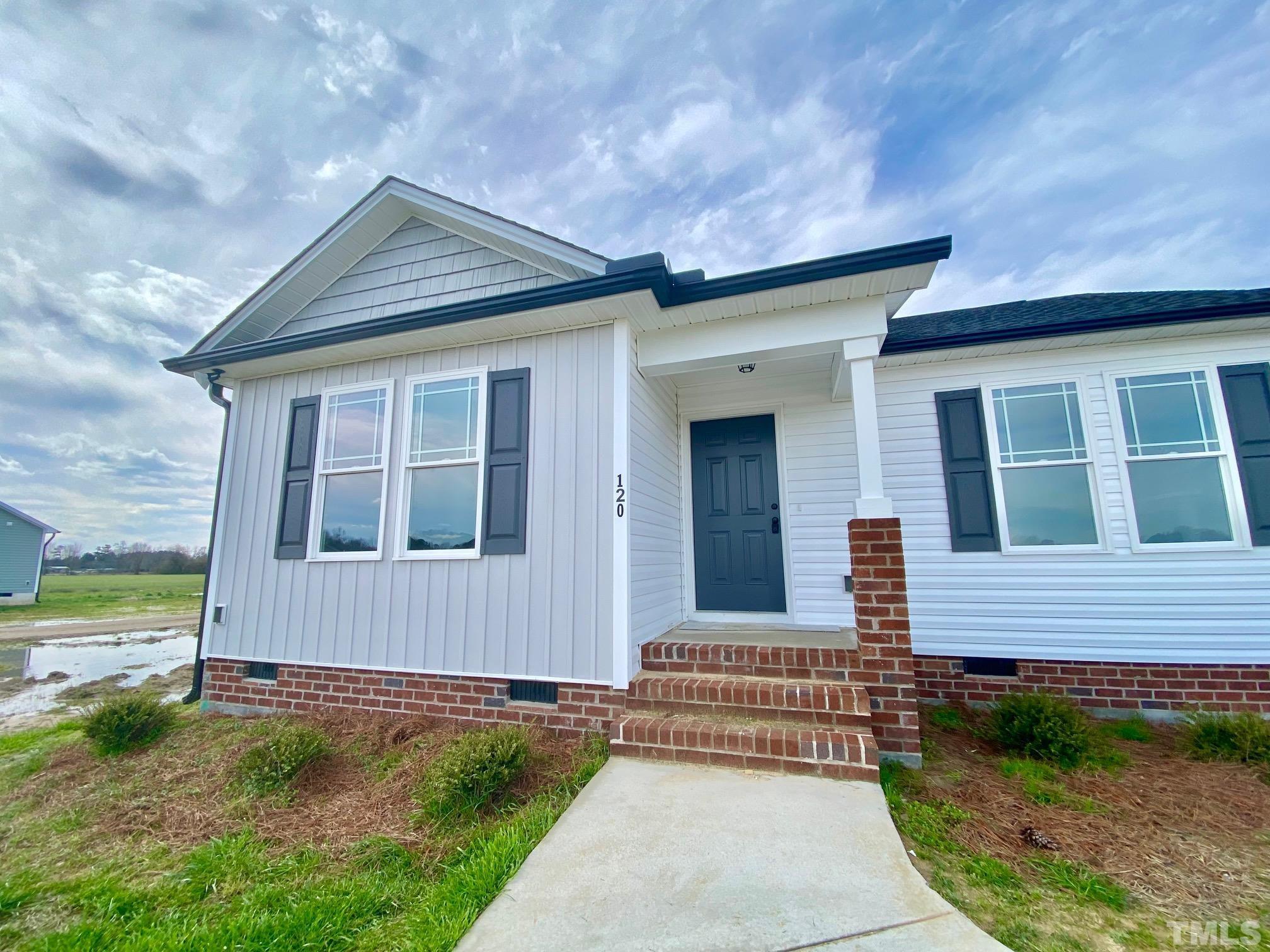 120 Mamie Road Benson, NC 27504 - Photo 4 of 35 a front view of a house with a yard