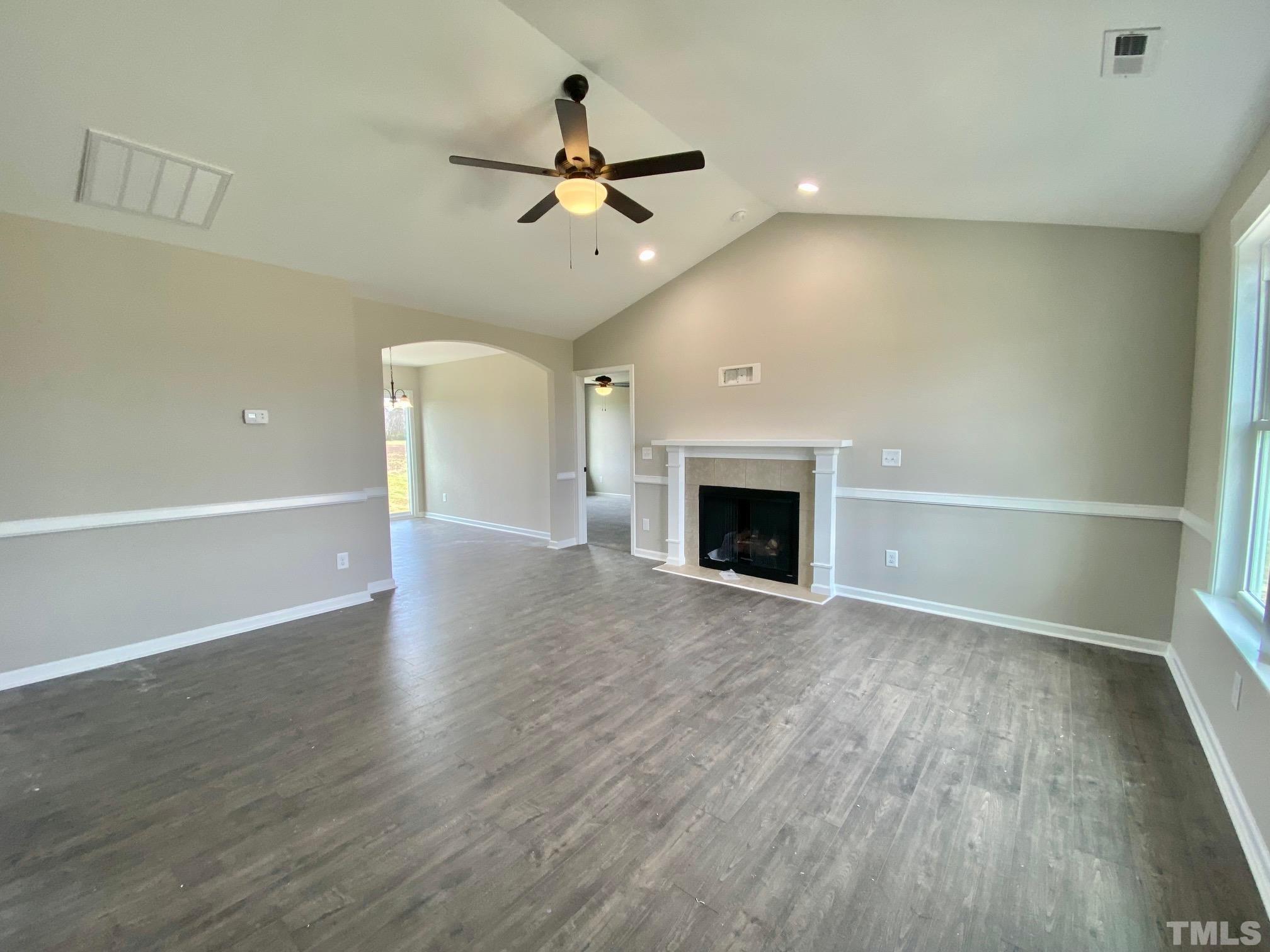 120 Mamie Road Benson, NC 27504 - Photo 6 of 35 a view of an empty room with wooden floor fireplace and a window