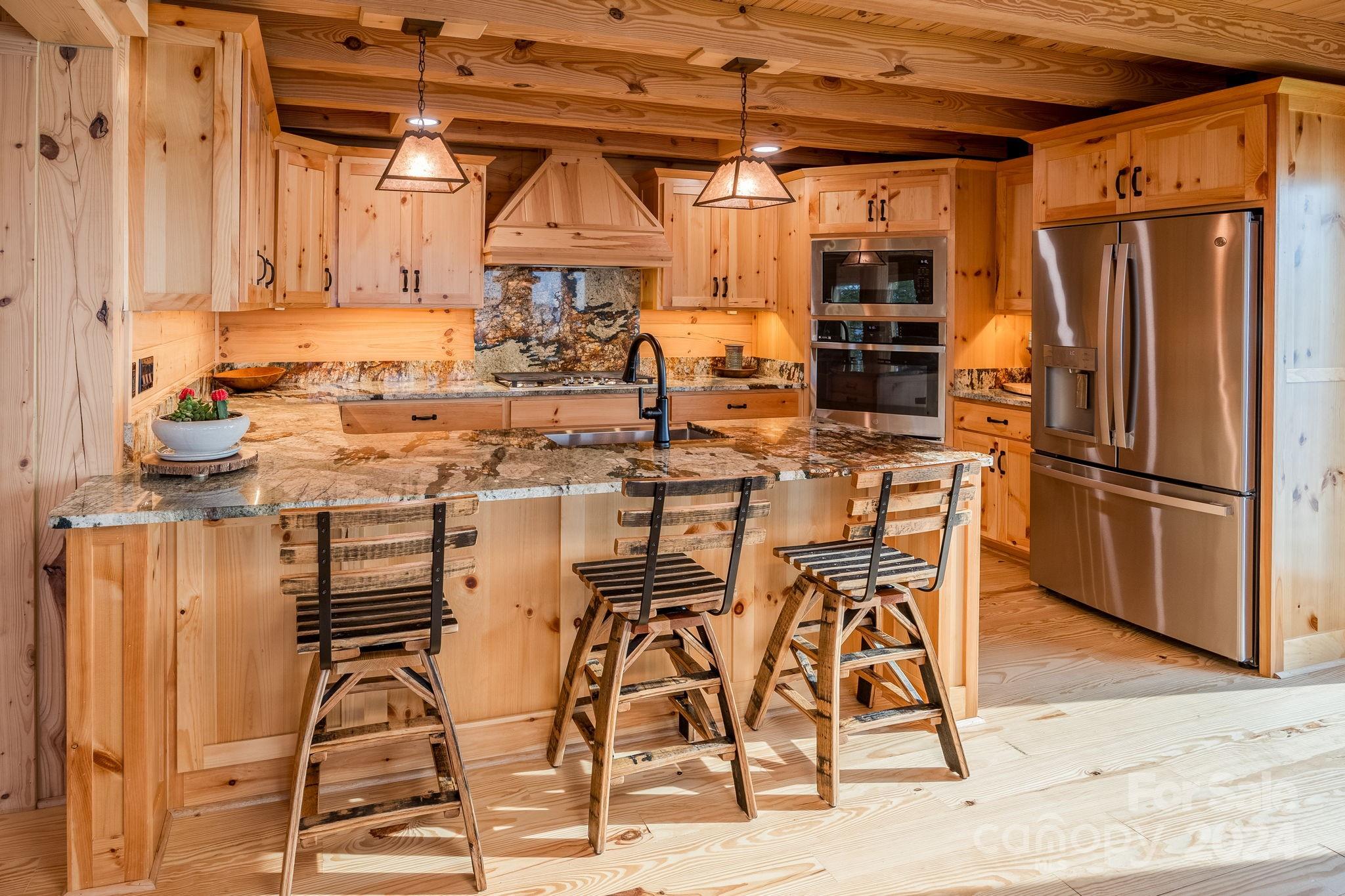 1958 Boxelder Trail Ridgeway, SC 29130 - Photo 12 of 46 a dining area with stainless steel appliances kitchen island granite countertop a refrigerator and microwave